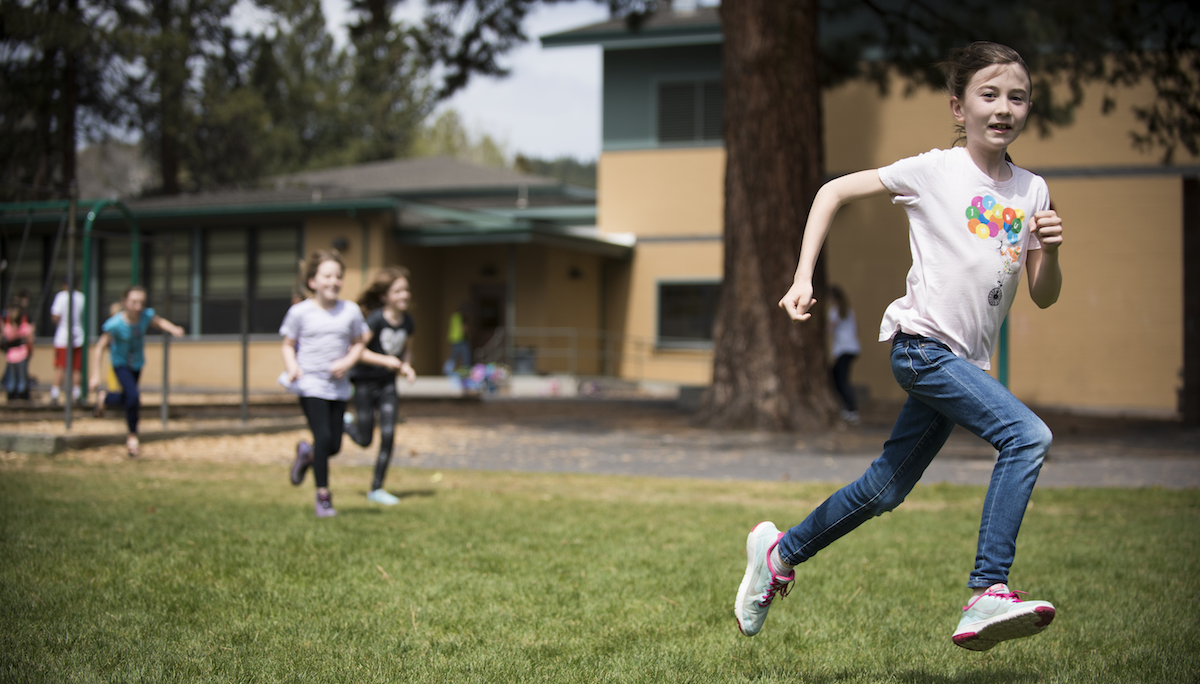 Girl running through playground