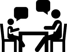 Child talking to adult at a table
