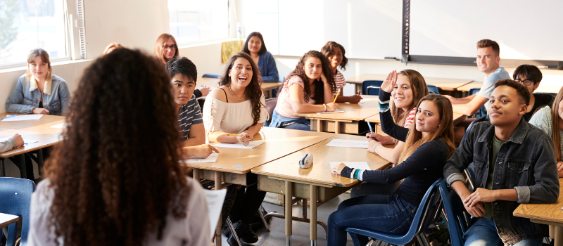 high school classroom full of students looking at teacher